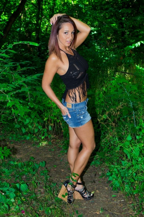 Amateur MILF Nikki Sims in woods sheds shorts to pose non nude in black thong 42423686