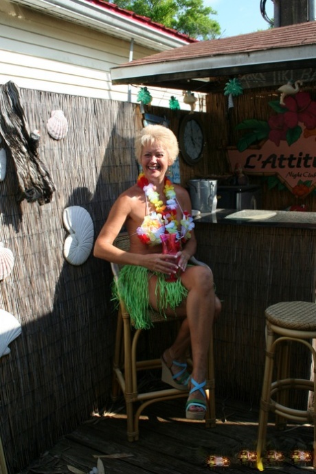 Mature woman Tracy Lick frees her horny cunt from grass skirt at swing club 73109447