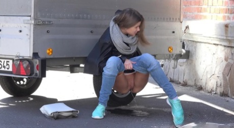 Sarah Key can't hold her pee any longer and pisses behind a trailer 16956916