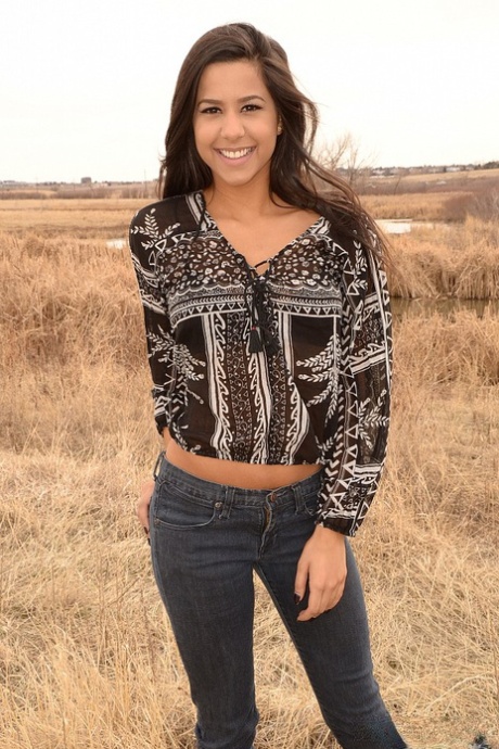 Latina girl Bella Quinn models in a field wearing a bra and jeans 80385557