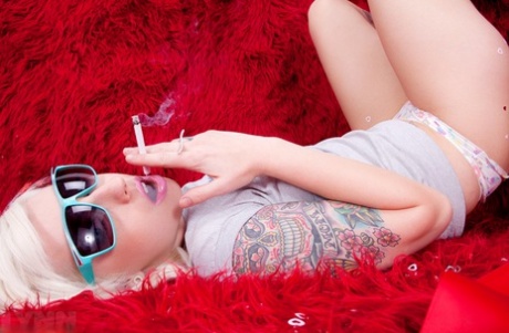 Tattooed blonde Lynn Pops smokes a cigarette before masturbating with a toy 11816170