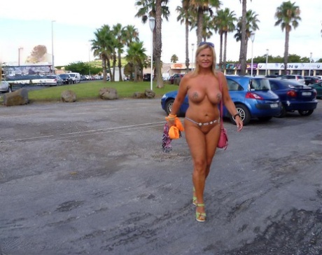 Busty blonde Nude Chrissy wanders a nude resort while mostly nude 54178283