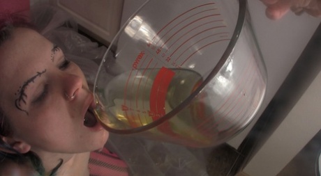 Caucasian chick Lily pisses in a glass measuring cup before drinking it 55497028