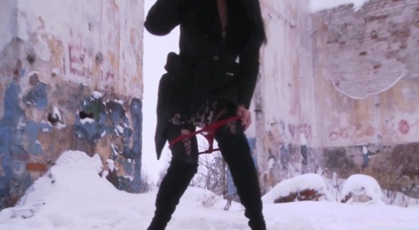 Dark-haired woman Dasha reveals her shaved pussy while peeing on the snow 15679908