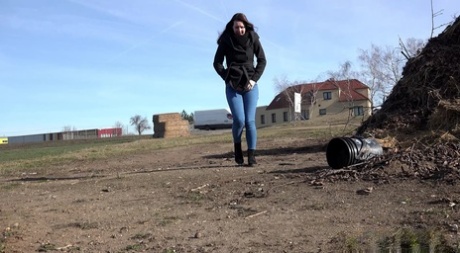 Solo girl Amanda Hill pulls down her jeans to pee in an empty lot 95215893