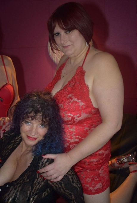 Older women participate in a lesbian threesome upon a bed in lingerie 88115555