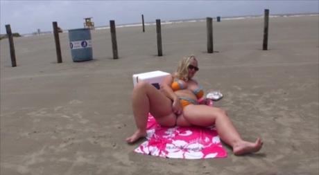 Overweight blonde Dee Siren removes her bikini to go nude on a beach 11725072