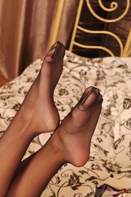 Solo girl with long curly hair plays with a dildo in sheer nylons and garters 40662872