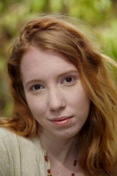 Natural redhead Nicki Blue shows some leg while wading into a shallow stream 67619177