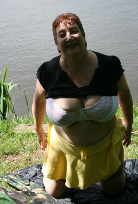 Older redhead Kinky Carol exposes her bra and underwear near the water 50041368
