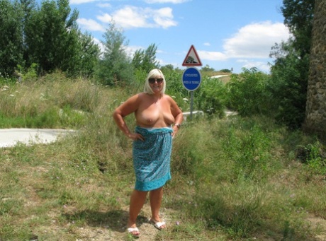 Older blonde BBW Chrissy Uk exposes her tits on a path through the woods 66415152