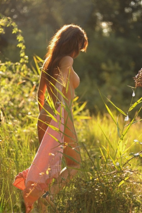 Natural redhead Tori B strikes great nude poses on moss covered ground 79991495