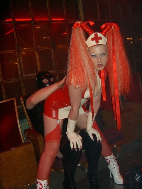 Caucasian female dominates a submissive male while wearing latex fetish wear 69450743