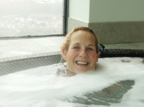 Mature blonde Molly MILF sinks into a hot tub while wearing lingerie 96480166
