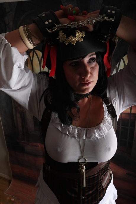 Dark-haired woman Sara Banks sports handcuffs while outfitted in pirate attire 19620980