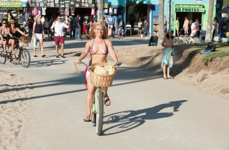 Older blonde babe Stevie Lix letting boobs free from bikini on beach 77475098