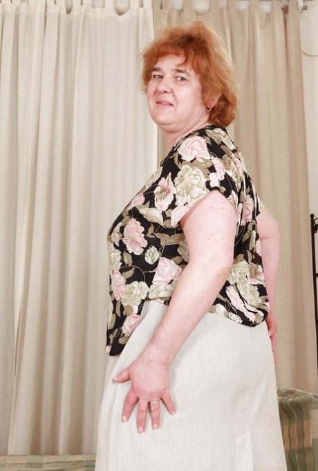 Mature plumper Andrea Blue stripping and exposing her unshaven bush 60127164