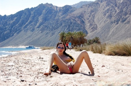 Raunchy brunette in sunglasses posing barely clothed outdoor 99780003